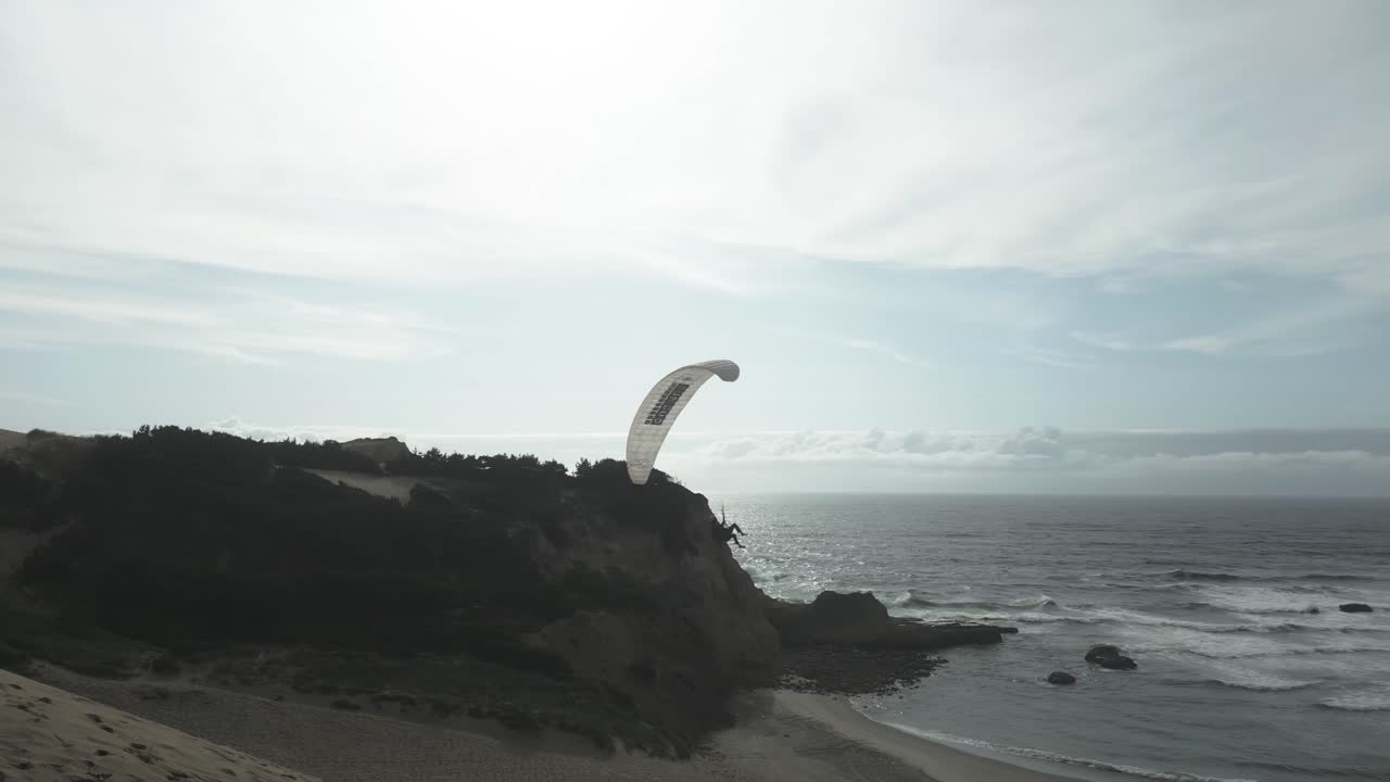 Paragliding Activity At Cape Kiwanda On Pacific Coast In Oregon, USA. tracking drone shot