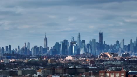 an aerial view of the east side of new york city from over flushing meadows corona park in queens on a cloudy day