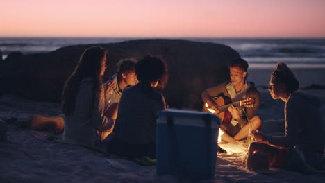 beach party at sunset with bonfire and roasting marshmellows with friends