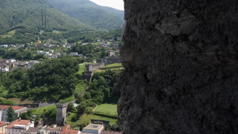 stunning-view-from-castle-in-Bellinzona-Switzerland,-tall-historical-architecture-residential-living-below-Forrest