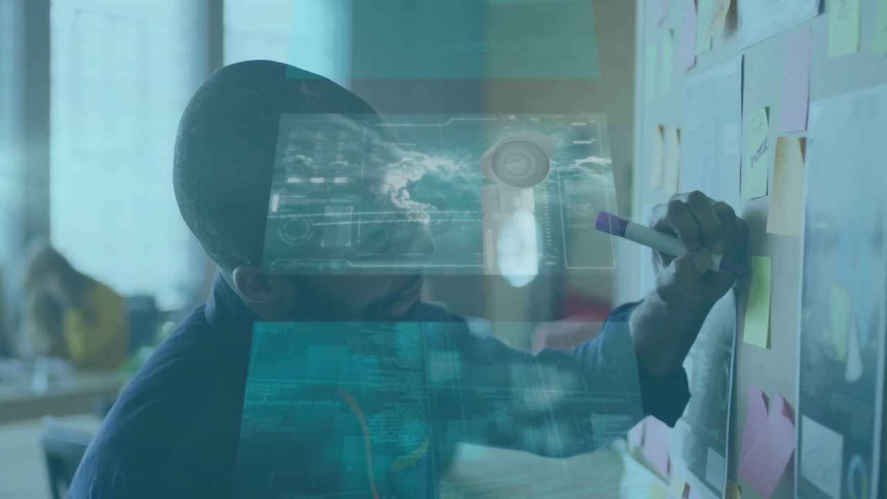 Designer leaning on sticky note wall, writing plans in tech workspace, with holographic diagrams