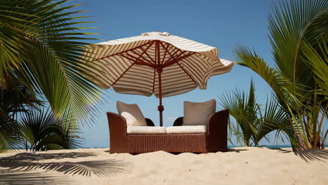 relaxing beach scene with outdoor sofa and umbrella