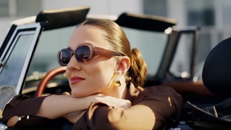 woman in a classic convertible car