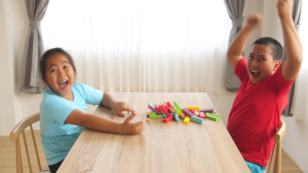 Asian Kids Play Wood Block Tower Game