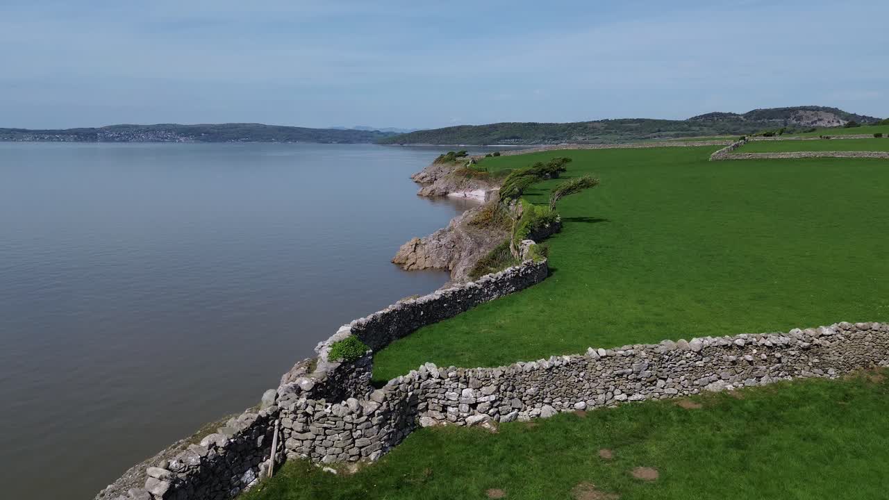 Morecambe bay coastal stone walled farmland aerial view overlooking Lake district mountain horizon