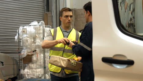 man delivering courier to warehouse worker