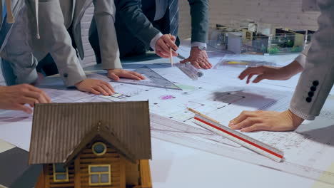 Team in a Brainstorming Session: Architects and Real Estate Developers working on house layout in office studio. Concept of war room, meeting teamwork and dashboard