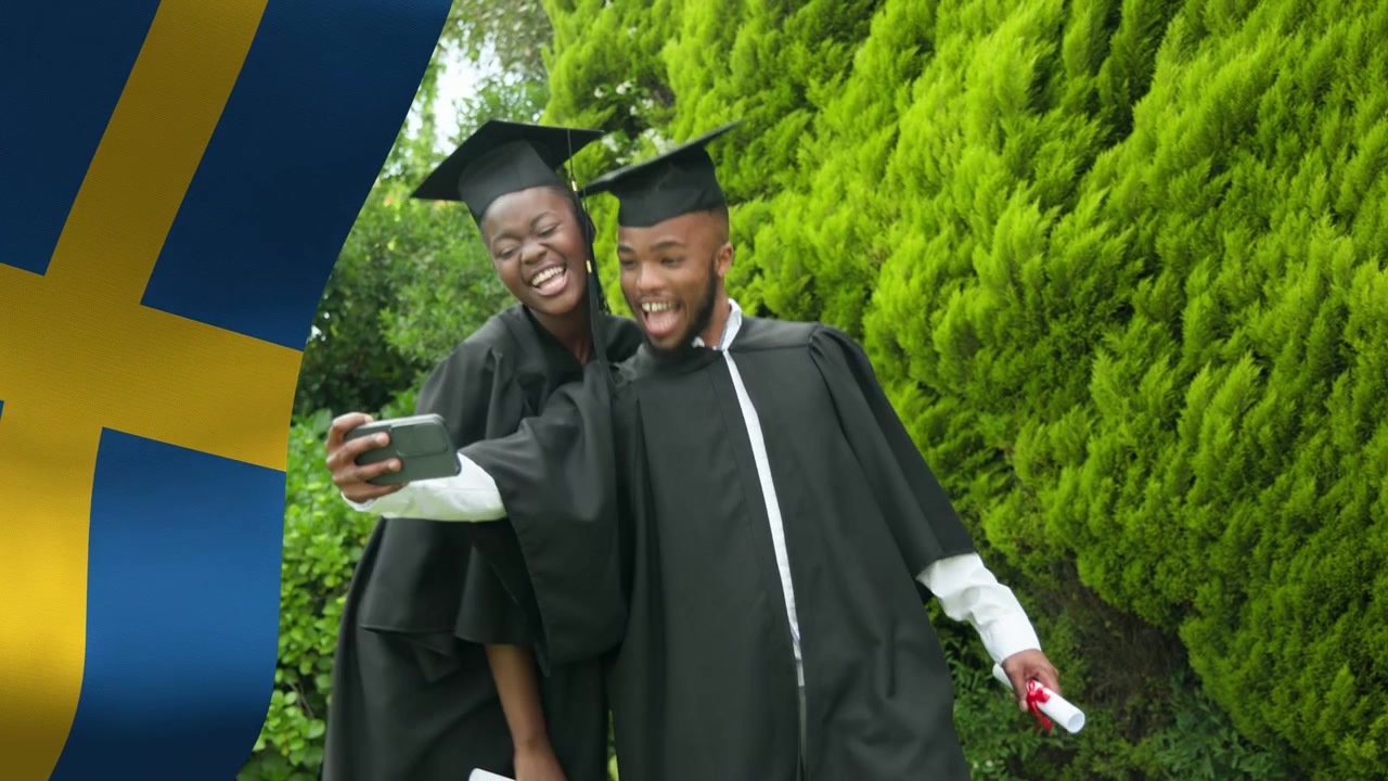 Two graduates retrieving phone for selfie beside hedge, blue-yellow overlay highlighting diplomas