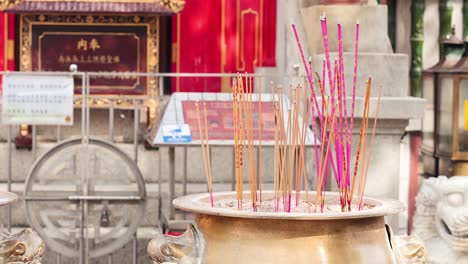 incense sticks burning in a temple setting