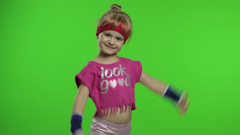 athletic girl in pink sportswear showing muscles isolated over green screen, chroma key background