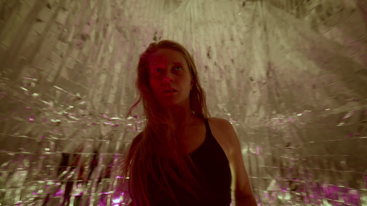 Female Dancer Performing Fluid, Expressive Movements under Colorful Lights