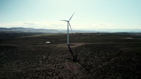 Slowly-orbiting-a-single-wind-driven-turbine-in-the-high-desert,-aerial