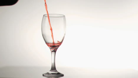 red wine poured in super slow motion in a glass