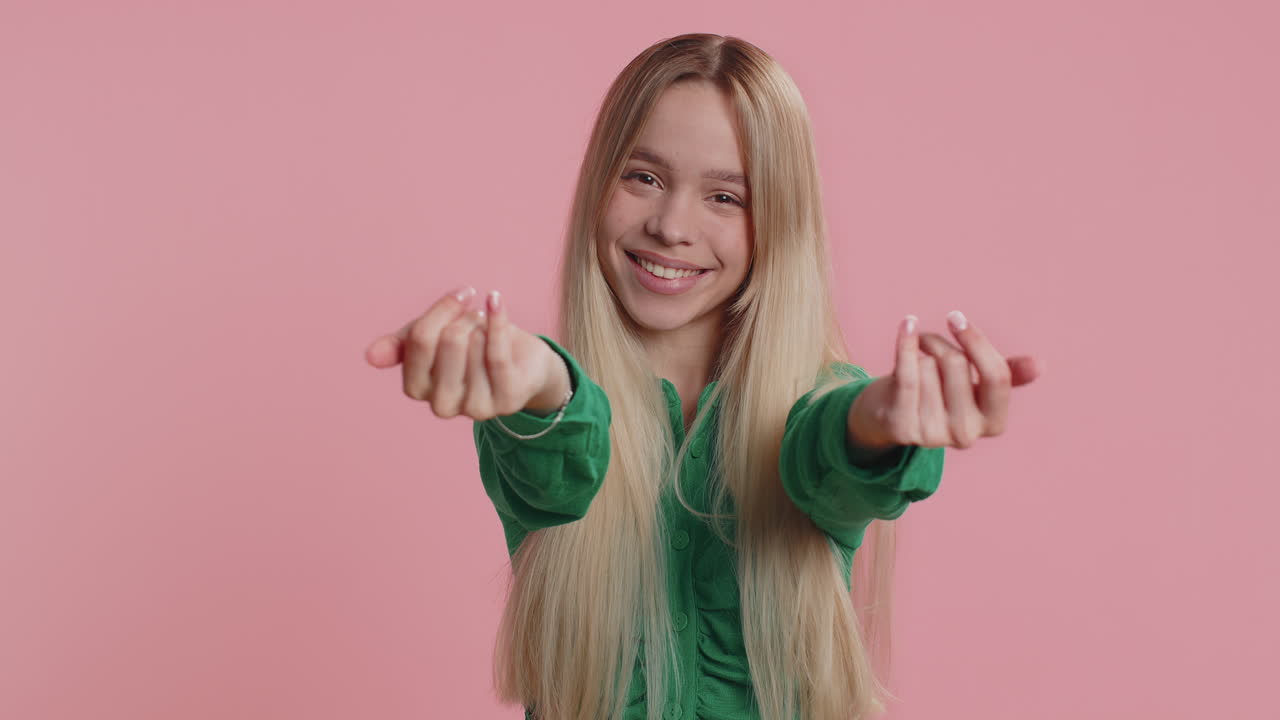 Woman showing inviting gesture with hands ask to join beckoning to coming gesturing hello goodbye