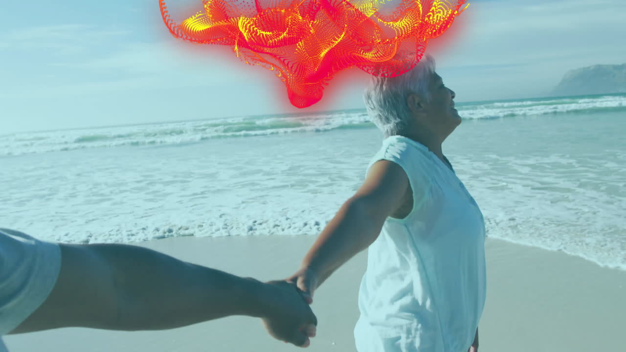 couple holding hands at shoreline, showing health data overlay with heart icon next to gentle waves