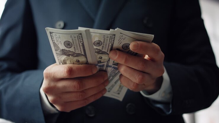 Businessman hands counting dollars close up. Unknown man calculating paper bills