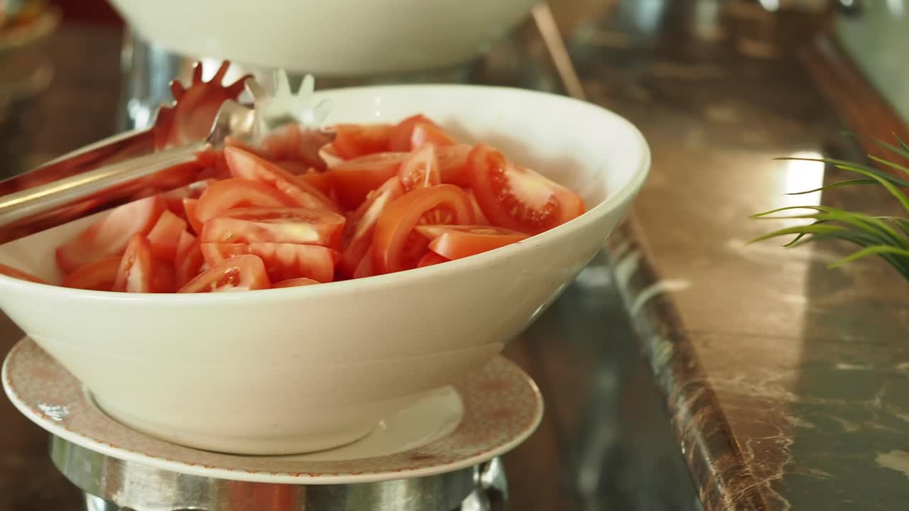 Sliced Tomatoes in a Bowl at a Buffet