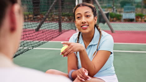 a woman sitting on a tennis court