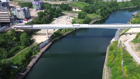 aerial flying towards keel crossing footbridge on river wear, city of sunderland, uk