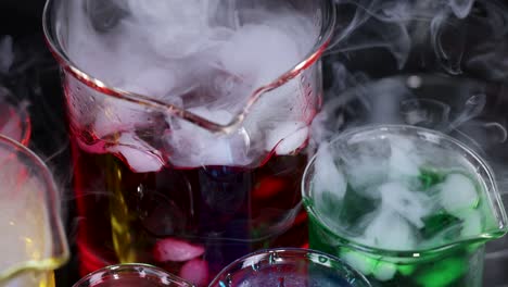 beakers with dry ice create colorful smoke effects