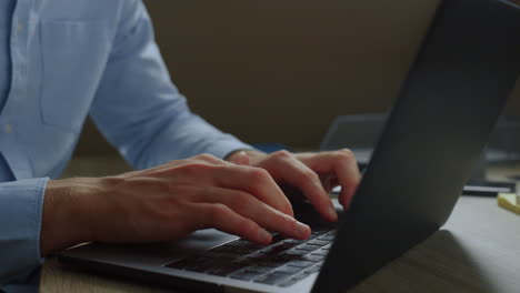 businessman hands typing email message on laptop. guy browsing internet online