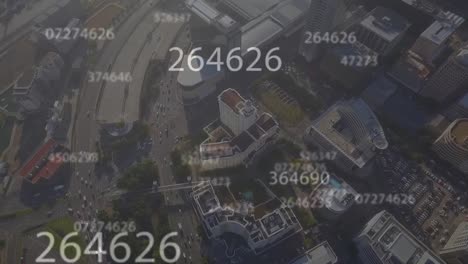 Animation-of-changing-numbers-over-aerial-view-of-city-in-background