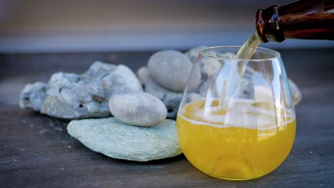 Pouring-a-cold-beer-into-a-stemless-glass