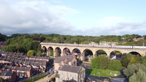 train crossing viaduct in durham town centre - aerial drone 4k hd