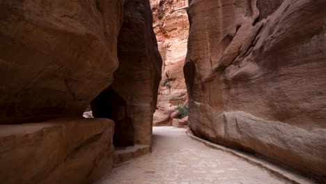 walking inside the al siq canyon towards the treasury in ancient city of petra