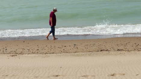 a tourist walks along the cold waters of the great lakes