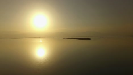 hot sunrise over the dead sea islands of salt