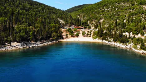 calm blue waters and scenic view of foki beach in greece - aerial shot