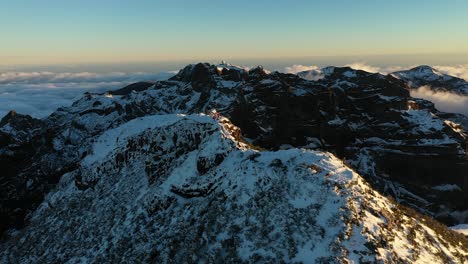 Cinematic-drone-shot-over-a-group-of-people-standing-on-the-peak-of-a-mountain-in-Madeira