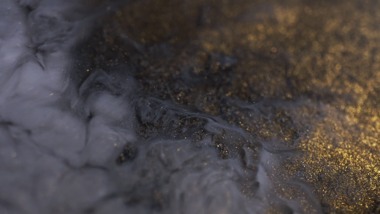 De l’encre en mouvement créant des formes artistiques simulant une fumée épaisse