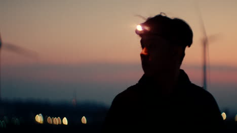 person with headlamp at sunset