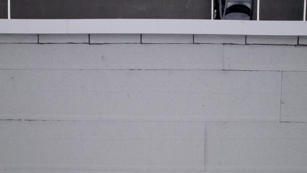 Aerial View of a Delivery Driver in a White Van in a Parking Lot