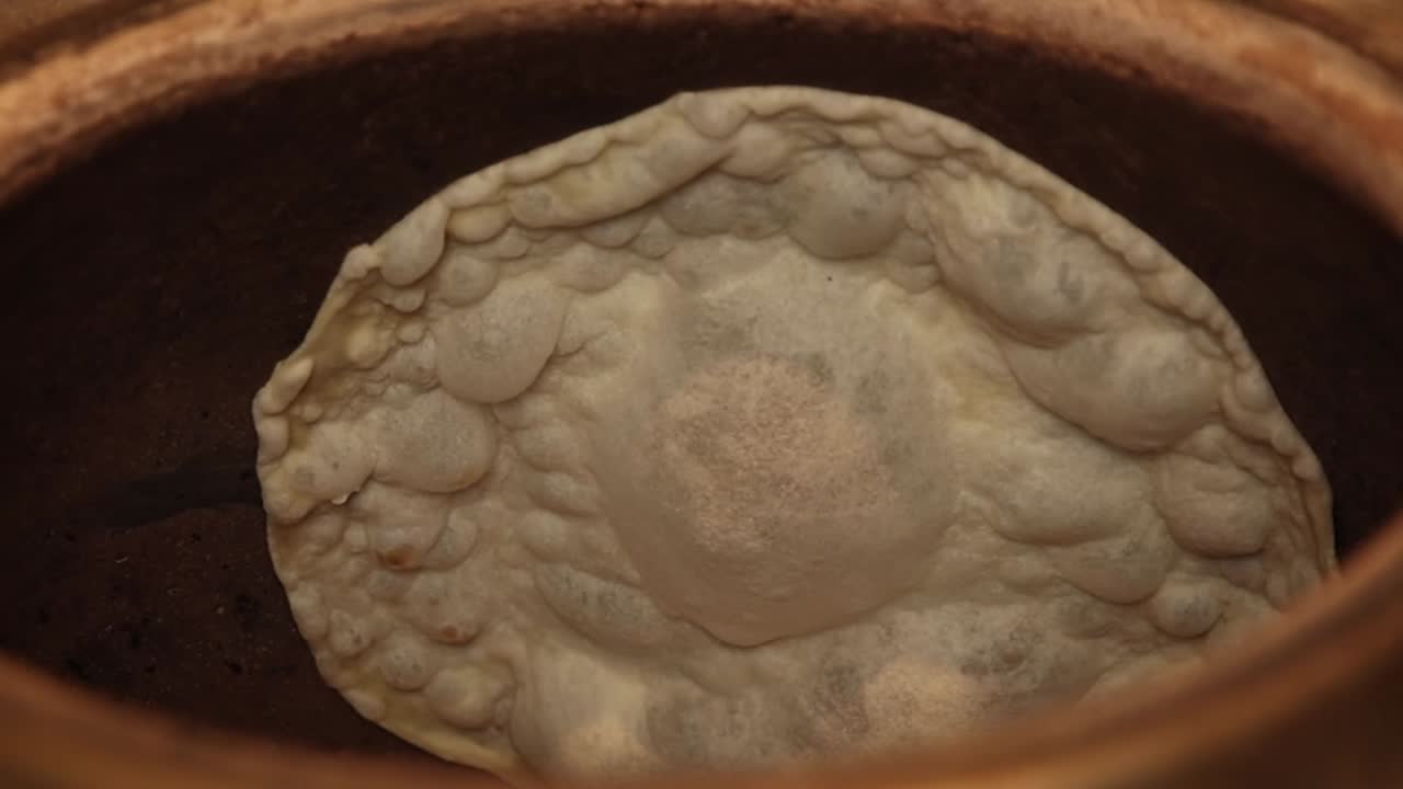 Naan Bread Cooking in Tandoor Oven