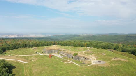 the entrance to the fort of douaumont in the middle of the countryside and the green forests towards verdun, in the meuse, in lorraine in the great east of france, in summer and by drone.