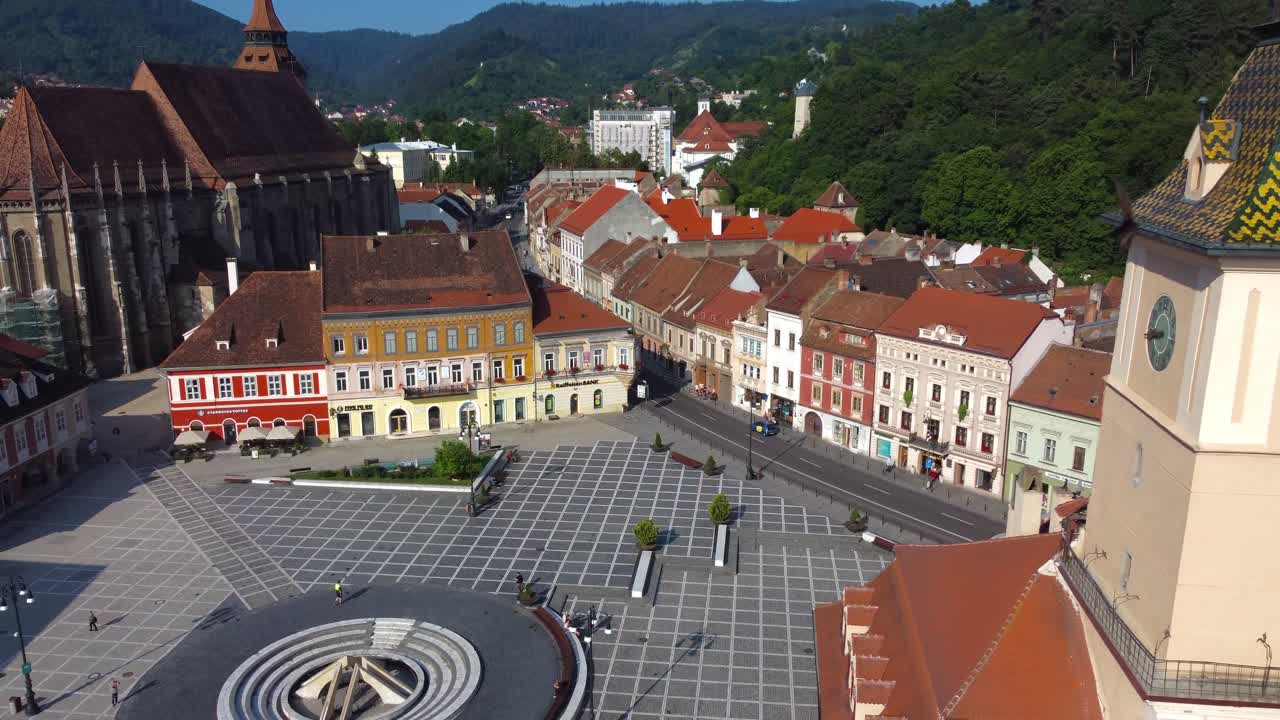 Drone retreating to reveal beautiful main square of Brasov, with Town Hall and The Black Church - Romania