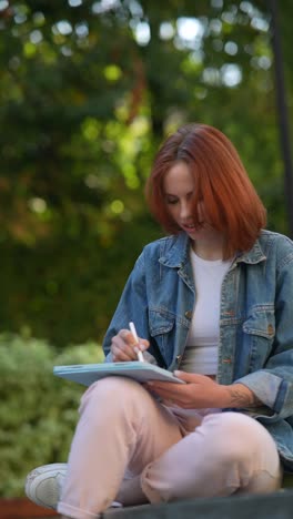 woman sketching in a park