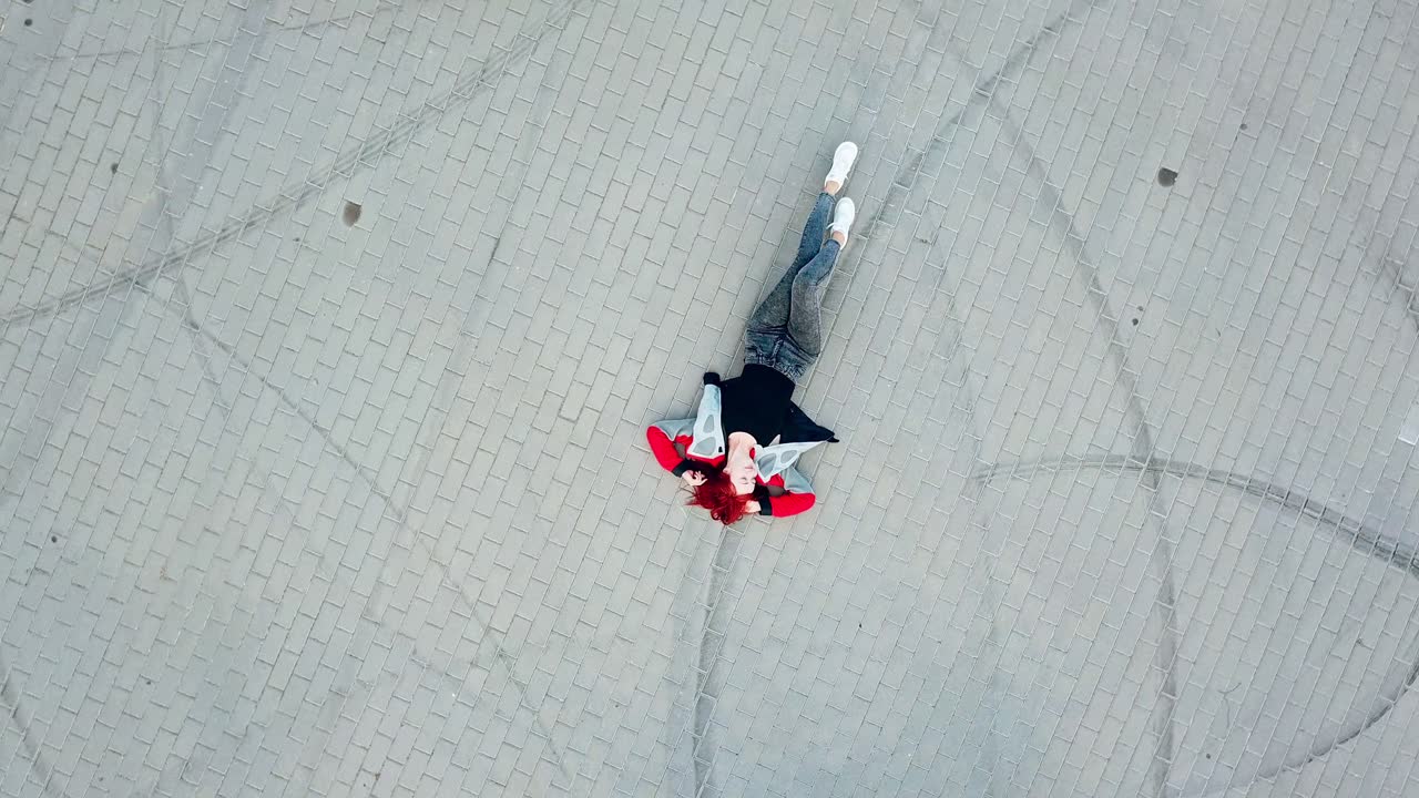 Motorcycle drive around woman. Top view of motorcycles driving around lying woman