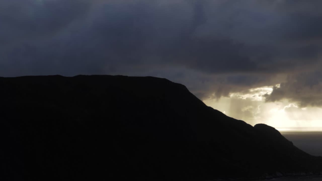 Sunset with rain clouds over Hoddevik in Norway, handheld dramatic view