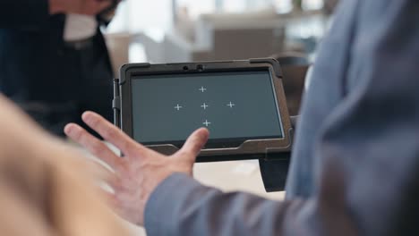 camera glides to tablet with tracking markers amid gesturing retail chat