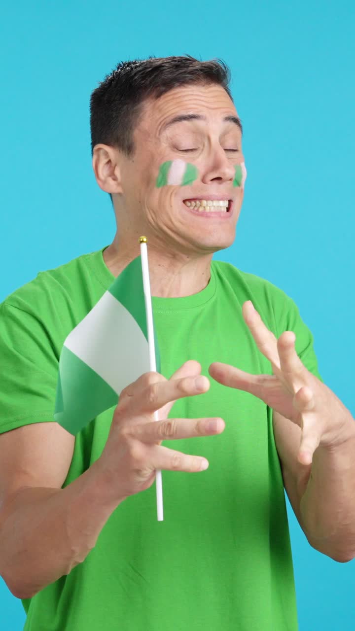 Man cheering for Nigeria during a match that is lost