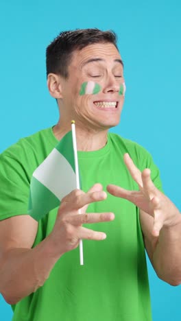 Man cheering for Nigeria during a match that is lost