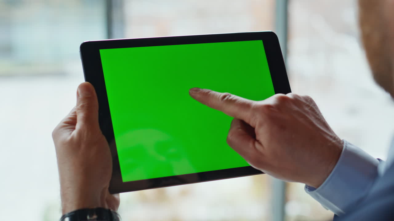 Businessman tapping chromakey tablet at corporate office closeup. Unknown man
