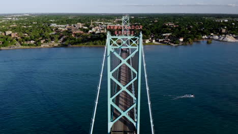 aerial footage approaching the ambassador bridge in detroit, michigan at sunset