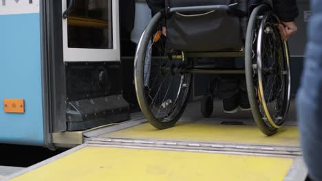 person with a physical disability enters public transport with an accessible ramp