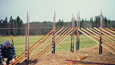 man constructing skigard (tradional fence) in norway - timelapse