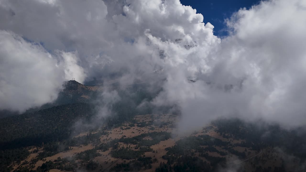 Ascending drone shot revealing the Popocatépetl volcano from Paso de Cortés, Mexico